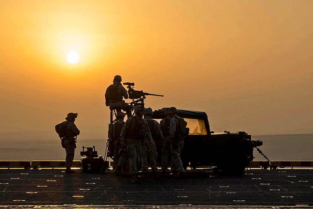 U.S. Marines stand watch on the flight deck of the amphibious assault ship USS Kearsarge while transiting the Suez Canal, April 5, 2013. The Kearsarge is the flagship for the Kearsarge Amphibious Ready Group and is supporting maritime security operations and theater security cooperation efforts in the U.S. 5th Fleet area of responsibility. The Marines are assigned to the 26th Marine Expeditionary Unit.  
