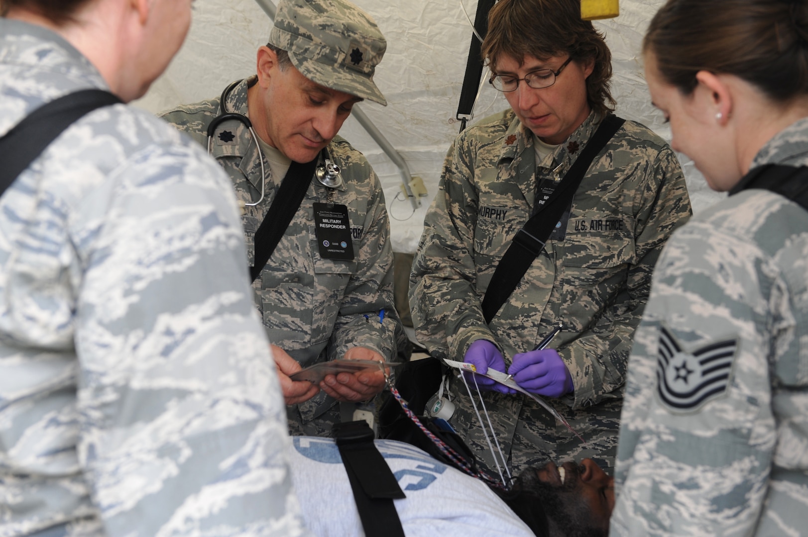 Airmen of the 193rd Special Operations Medical Group, 193rd Special Operations Wing evaluate a casualty during a simulated emergency disaster in a contaminated environment May 14, 2014, during the exercise Vigilant Guard at Fort Indiantown Gap, Pa. Lt. Col. Richard Lorraine, a flight surgeon, left, and Maj. Ruthann Murphy, a critical care nurse, right, are part of a specialized chemical, biological, radiological, and nuclear Enhanced Response Force Package that respond to mass casualty events. 