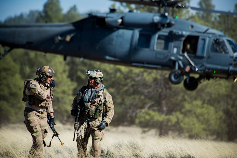 Pararescuemen make their way from a helicopter landing zone May 9, 2014, during an Angel Thunder mass-casualty exercise at Camp Navajo, Ariz. The pararescuemen are assigned to the 58th Rescue Squadron at Nellis Air Force Base, Nev. Though stationed at Nellis AFB, the 58th RQS is a geographically-separated unit of the 23rd Wing at Moody AFB, Ga. The helicopter and its crew are from the 41st Rescue Squadron, from Moody AFB. (U.S. Air Force photo/Staff Sgt. Jamal D. Sutter)