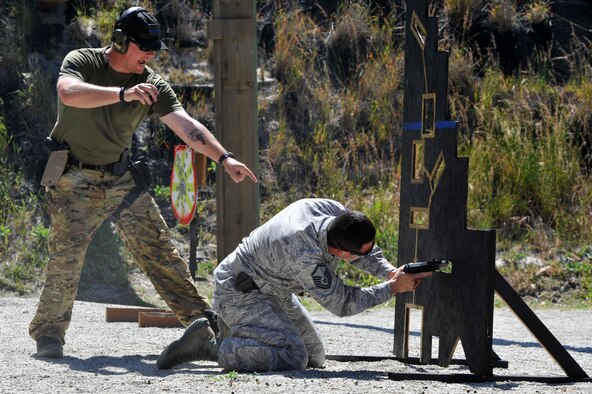  Staff Sgt. Daniel Kane directs a competitor May 13, 2014, during the Law Enforcement Pistol Shoot event at Vandenberg Air Force Base, Calif. Kane is the range safety officer with the 30th Security Forces Squadron. The pistol shoot was open to all military and local law enforcement officers as part of a National Police Week celebration at Vandenberg AFB. (U.S. Air Force photo/Michael Peterson)