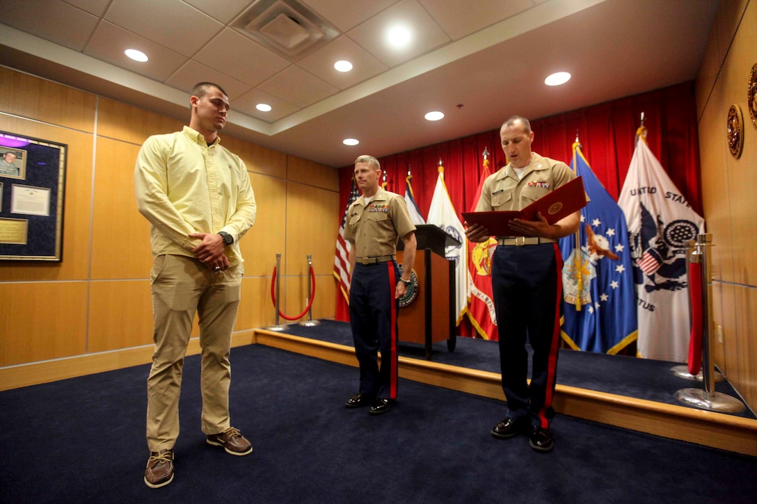 PITTSBURGH--Joseph Cosentino, a native of Pittsburgh and a graduate of Pittsburgh Central Catholic high school, received a Certificate of Appreciation for playing in the 2013 Semper Fidelis All-American Bowl from Maj. John Hunt, commanding officer of the United States Marine Corps Recruiting Station Pittsburgh, May 15. Following his senior year of highs Cosentino is slated to play for Florida State University, the champions of the 2013 college football season, as a quarterback. (U.S. Marine Corps photo by Lance Cpl. Brandon Thomas)