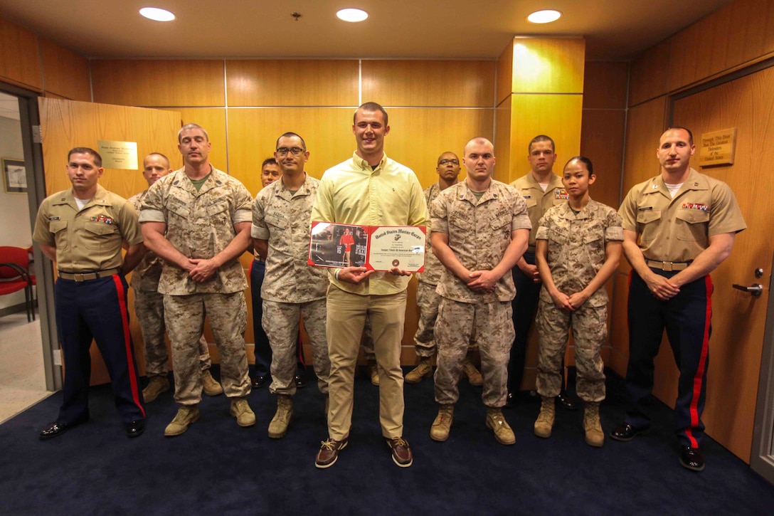 PITTSBURGH--Joseph Cosentino, a native of and a graduate of Pittsburgh Central Catholic high school, poses for a picture with the Marines from Recruiting Station Pittsburg after receiving a Certificate of Appreciation for playing in the 2013 Semper Fidelis All-American bowl from Maj. John Hunt, commanding officer of the United States Marine Corps Recruiting Station Pittsburgh, May 15. Following his senior year of high school Cosentino is slated to play for Florida State University, the champions of the 2013 college football season, as a quarterback. (U.S. Marine Corps photo by Lance Cpl. Brandon Thomas)re