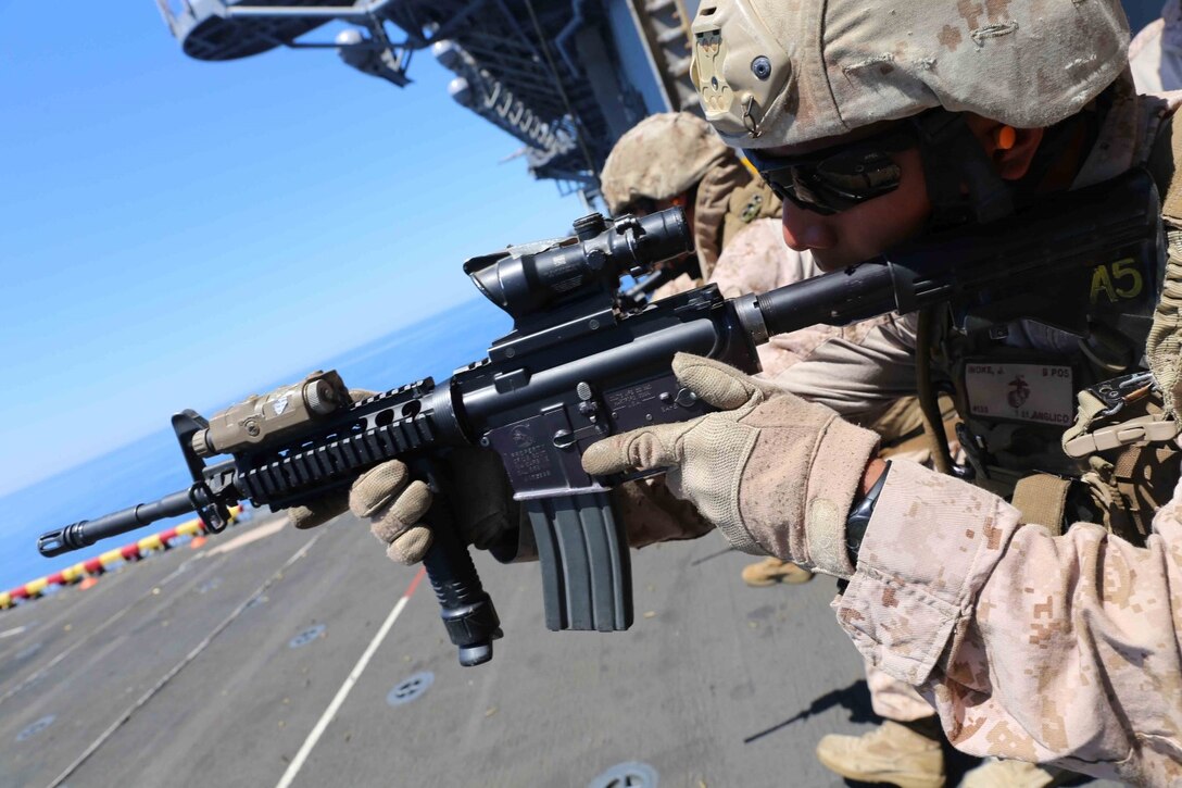 Lance Cpl. Jodie Inoke, a radio operator with 1st Air Naval Gunfire Liaison Company (ANGLICO), fires his M4 carbine as part of close quarter tactics (CQT) training during Composite Training Unit Exercise (COMPTUEX) off the coast of southern California, May 15, 2014. COMPTUEX is the second at-sea period during the 11th MEU's predeployment cycle, in which the MEU will conduct concurrent mission planning and execution integrated across all element of the Marine Air Ground Task Force while supporting Amphibious Squadron 5 in their evaluated training. (U.S. Marine Corps photo by Cpl. Demetrius Morgan/Released)