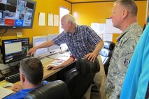 Chuck Wood, assistant project manager with URS, shows Col. Robert Ruch, commander, U.S. Army Engineering and Support Center, Huntsville, how employees in the control room monitor the detonation process through the use of computer screens during a site visit to the Static Detonation Chamber at Anniston Army Depot May 13. Ruch visited the Depot to see the SDC in operation.  The SDC is being used to process conventional munitions and ordnance to gain more information in support of non-stockpile efforts.  The technology will be installed at the Blue Grass chemical-agent destruction pilot plant in Richmond, Ky. 
