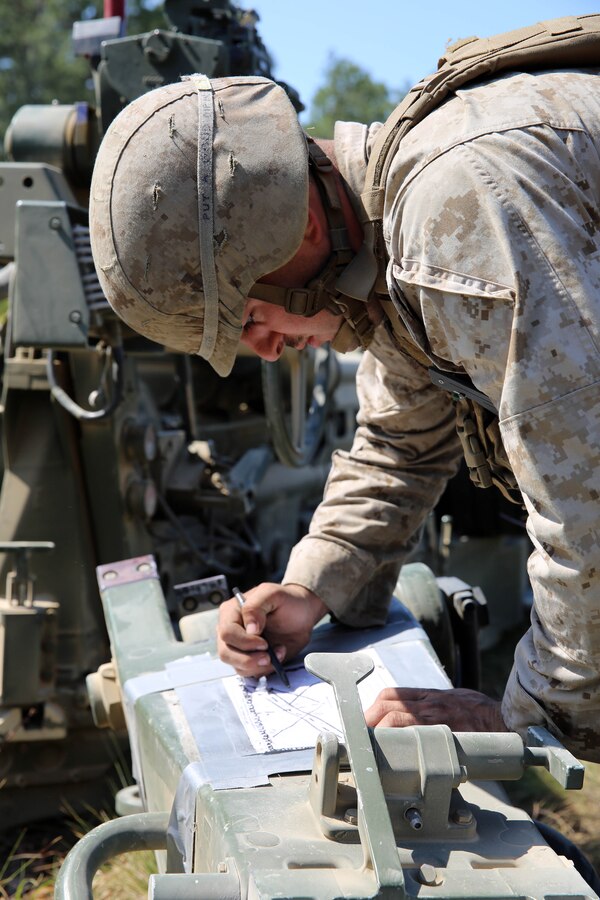 Lance Cpl Logan Helwig, a field artillery cannoneer with Alpha Battery, 1st Battalion, 10th Marine Regiment, 2nd Marine Division, draws a range sketch before firing the M-777 lightweight 155mm howitzer for the top gun competition as part of Rolling Thunder at Fort Bragg, N.C., May 5, 2014. Each battery within the regiment is graded on emplacement and knowledge of the weapons system, communications and the organization of the convoy out of the firing position, with the battery scoring the highest in each category claiming the title of Top Gun.