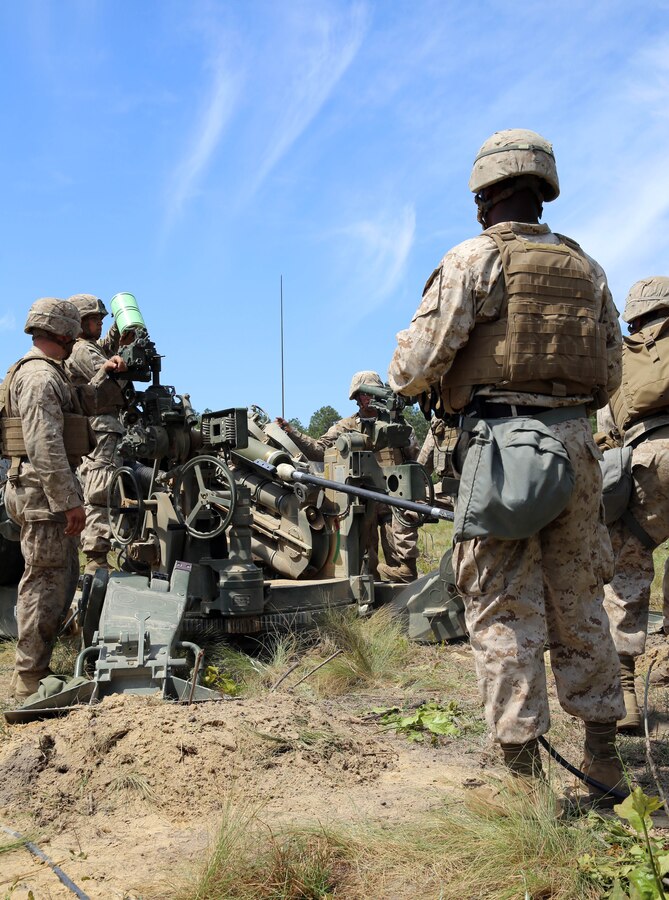 Marines with Echo Battery, 2nd Battalion, 10th Marine Regiment, 2nd Marine Division prepare to load and fire an M-777 lightweight 155mm howitzer for a Top Gun competition held at Fort Bragg, N.C., May 6, 2014. Being the main event of the field operation Rolling Thunder, each battery is graded on emplacement and knowledge of the weapons system, communications and organization of the convoy out of the firing position, in order to claim the title of Top Gun.
