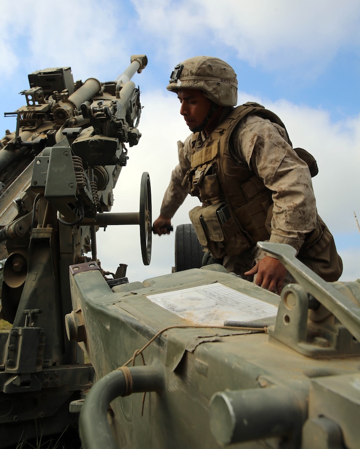 Lance Cpl Demetrio Morales, an assistant gunner with Kilo Battery, 1st Battalion, 10th Marine Regiment, 2nd Marine Division, changes the elevation on an M-777 lightweight 155mm howitzer at Fort Bragg, N.C., May 7, 2014. Marines with Kilo Battery were firing howitzers during a competition for the title Top Gun during the field operation Rolling Thunder. Top Gun is an internal competition within the regiment that showcases the capabilities of each battery through superior firepower and grades them on emplacement and knowledge of the weapons system, communications and organization of the convoy out of the firing position.