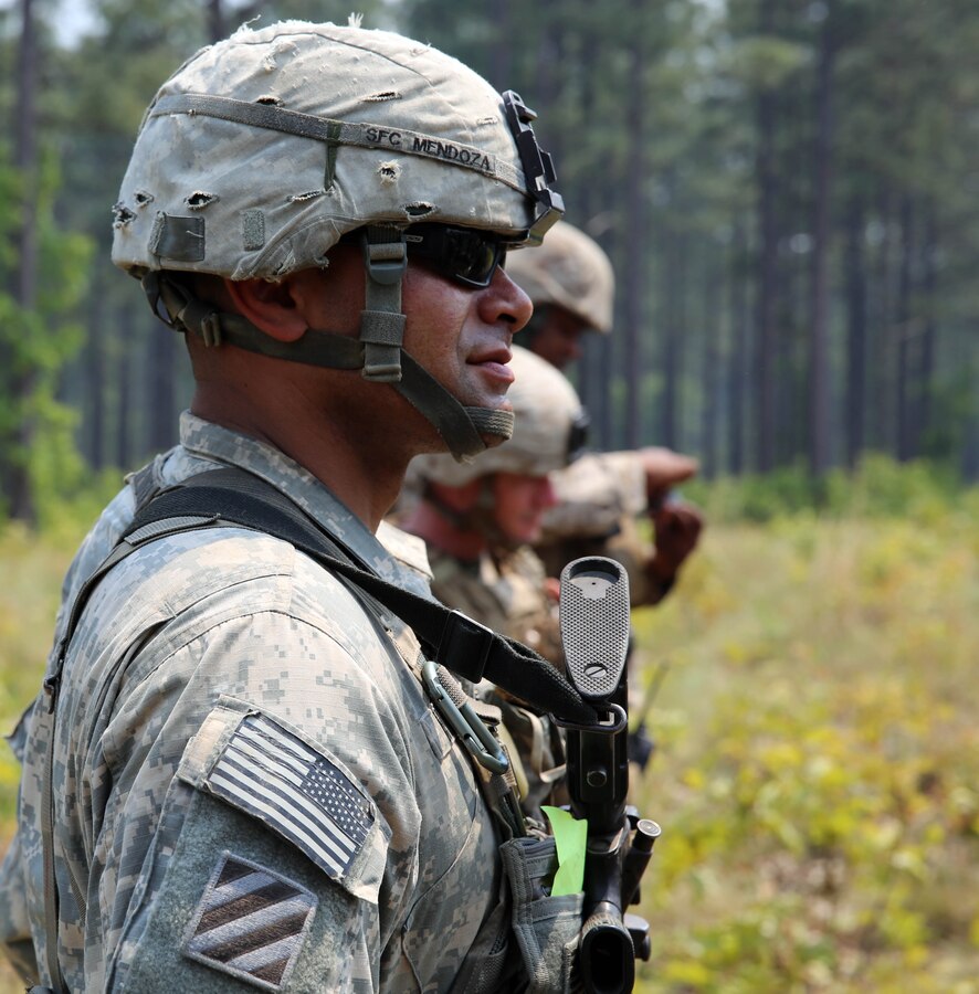 Sergeant 1st Class Freddy Mendoza, a platoon sergeant with Charlie Battery, 3rd Battalion of the 319th Field Artillery Regiment, 1st Brigade, 82nd Airborne Division overlooks as his soldiers emplace the M-119 lightweight 105mm howitzer during a competition for the title of Top Gun held at Fort Bragg, N.C., May 7, 2014. The soldiers integrated into training with Marines from 10th Marine Regiment, in order to showcase their abilities on the weapons systems and to compare differences in execution of emplacement and communications.