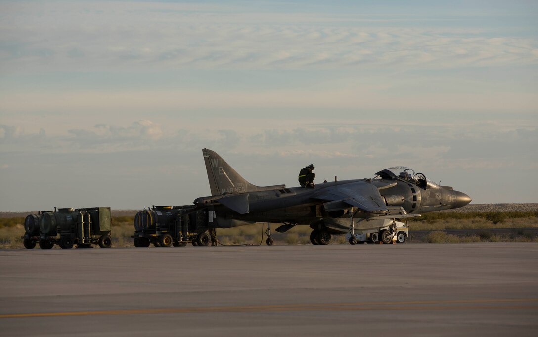Marines with Marine Wing Support Squadron 371 resupply water to an AV-8B Harrier with Marine Attack Squadron 214, at the new Auxiliary Landing Field (ALF) facility at MCAS Yuma, Ariz., Feb. 24. The new facility has bathrooms, a maintenance hangar, and vehicle bays, which allows them to support operations better than at the previous auxiliary landing field, AUX 2. 