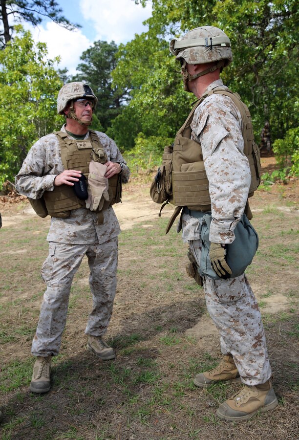 Brigadier Gen. James W. Lukeman, commanding general of 2nd Marine Division, and Lt. Col. Jarrod Stoutenborough, commanding officer of 2nd Battalion, 10th Marine Regiment, 2nd Marine Division, discuss the training that Marines with Fox Battery, 2 Bn., 10th Marines have been executing during Rolling Thunder aboard Army Base Fort Bragg, N.C., May 12, 2014. Rolling Thunder is a field event that allows the Marines to learn to work more efficiently as a regiment and contributes to regimental cohesion by pushing each battery to excel in fire missions during day and night operations.