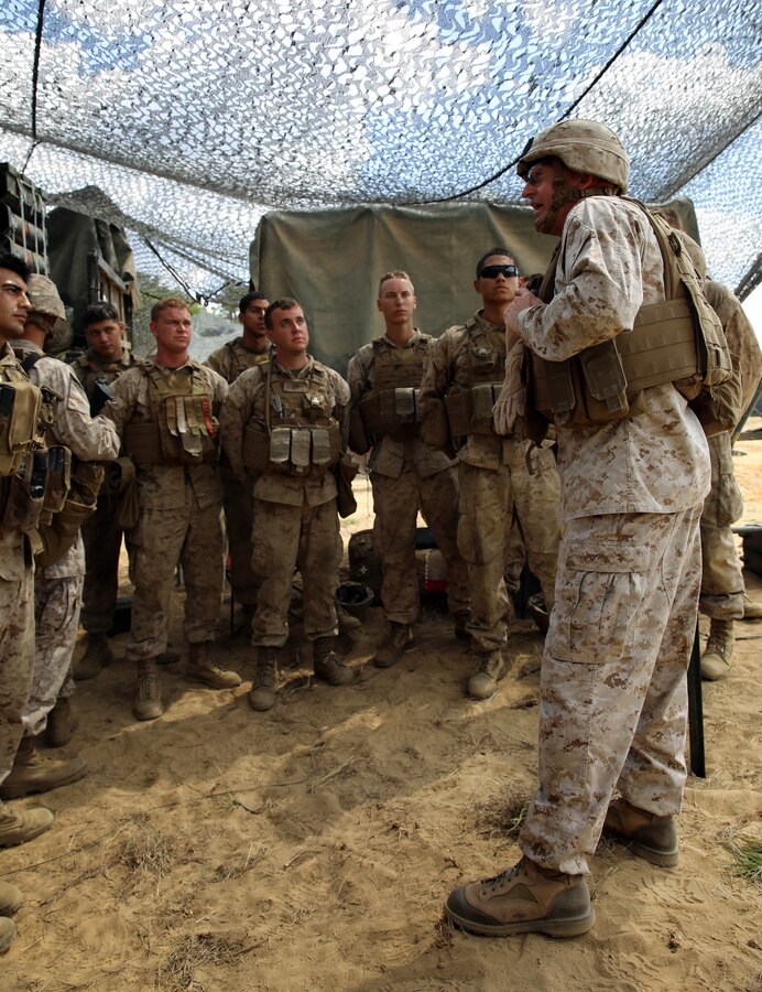 Brigadier Gen. James W. Lukeman, commanding general of 2nd Marine Division, talks to Marines with Fox Battery, 2nd Battalion, 10th Marine Regiment, 2nd Marine Division, about the importance of sustainment training during a command visit for the field operation Rolling Thunder aboard Fort Bragg, N.C., May 12, 2014. During the visit, Lukeman and Sgt. Maj. Bryan Zickefoose, sergeant major of 2nd Marine Division commended Marines within the regiment on their continued success and performance.