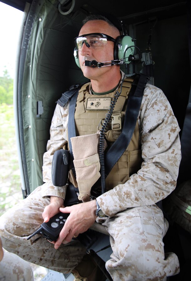 Brigadier Gen. James W. Lukeman, commanding general of 2nd Marine Division, rides in a UH-60 Black Hawk helicopter for a command visit while observing rounds impact during fire missions as part of the field operation Rolling Thunder, May 12, 2014. During the visit, both Lukeman and Sgt. Maj. Bryan Zickefoose, sergeant major of 2nd Marine Division, observed all aspects of 10th Marine Regiment from the battery level all the way up to the regimental level.  