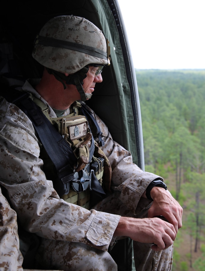 Sergeant Maj. Bryan Zickefoose, sergeant major of 2nd Marine Division, rides in a UH-60 Black Hawk helicopter for a command visit while observing rounds impact during fire missions as part of Exercise Rolling Thunder, May 12, 2014. During the visit, both Zickefoose and Brig. Gen. James W. Lukeman, commanding general of 2nd Marine Division, observed all aspects of 10th Marine Regiment from the battery level all the way up to the regimental level.  