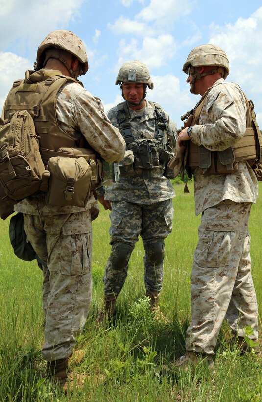 Brigadier Gen. James W. Lukeman, commanding general of 2nd Marine Division, and Col. Clifford Weinstein, commanding officer of 10th Marine Regiment, talk to LT. Col. Phil Jenison, battalion commander of 3rd Battalion of the 319th Field Artillery Regiment, 1st Brigade, 82nd Airborne Division, about training being conducted during a command visit for Rolling Thunder, May 12, 2014. Rolling Thunder is a biannual field operation in which Marines from all aspects of 10th Marine Regiment learn to work together to be more proficient in their jobs from the battery to regimental level.
