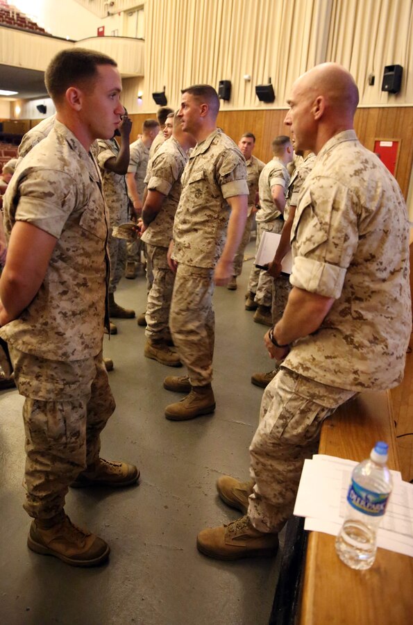 Sergeant Maj. Garritt Duncan (right), sergeant major of 2nd Reconnaissance Battalion, talks to Cpl. Justin Stark, a mortarman with 3rd Battalion, 2nd Marine Regiment, 2nd Marine Divsion, about the possibility of reenlisting as a reconnaissance Marine after a brief from the commanding officer and senior enlisted Marines from 2nd Recon,at the base theatre aboard Marine Corps Base Camp Lejeune, N.C., May 15, 2014. To become a reconnaissance Marine, Marines must first go through the basic reconnaissance course, a three phased course that hones in on reconnaissance individual and special skills, individual and team ocean amphibious skills and team communications and patrolling skills. 