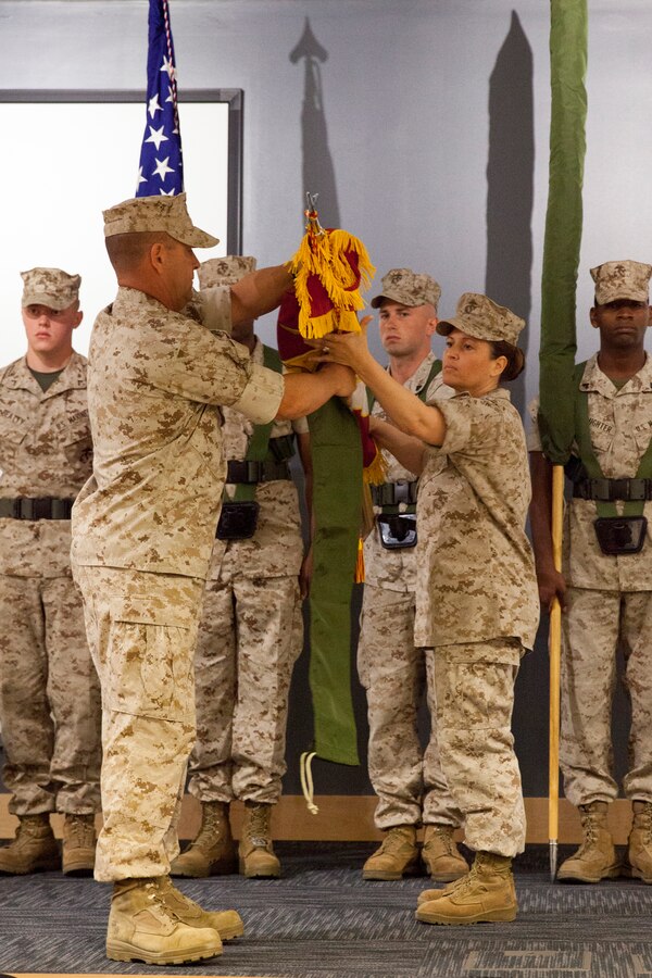 U.S. Marine Corps Lt. Col. Stephanie L. Walker, commanding officer, 2d Marine Special Operations Support Battalion (2d MSOSB) along with Sgt. Maj. Dardy J. Noonan Sgt Maj. 2d MSOSB, case the unit colors before uncasing the new unit colors during the re-designation ceremony where Marine Special Operations Logistics Battalion was re-designated as 2d MSOSB aboard Camp Lejeune, N.C., May 16, 2014.  The mission of 2d MSOSB is to provide logistics and Combat Service Support (CSS), and to train, equip, organize and provide CSS capabilities to 2d Marine Special Operations Battalion deploying in the execution of special operations. (U.S. Marine Corps photo by Sgt. Scott A. Achtemeier)
