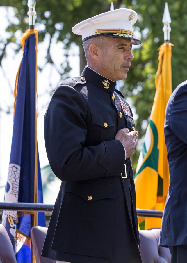 Brigadier General Paul K. Lebidine, commanding general, Force Headquarters Group stands with hand over heart as the Pledge of Allegiance is recited amongst a crowd of veterans and civilians during a ceremonial display of the Vietnam Veterans Memorial Moving Wall in Kenner, Louisiana, May 16, 2014. Vietnam veterans built the moving wall replica and it has been traveling the country for more than 30 years. 