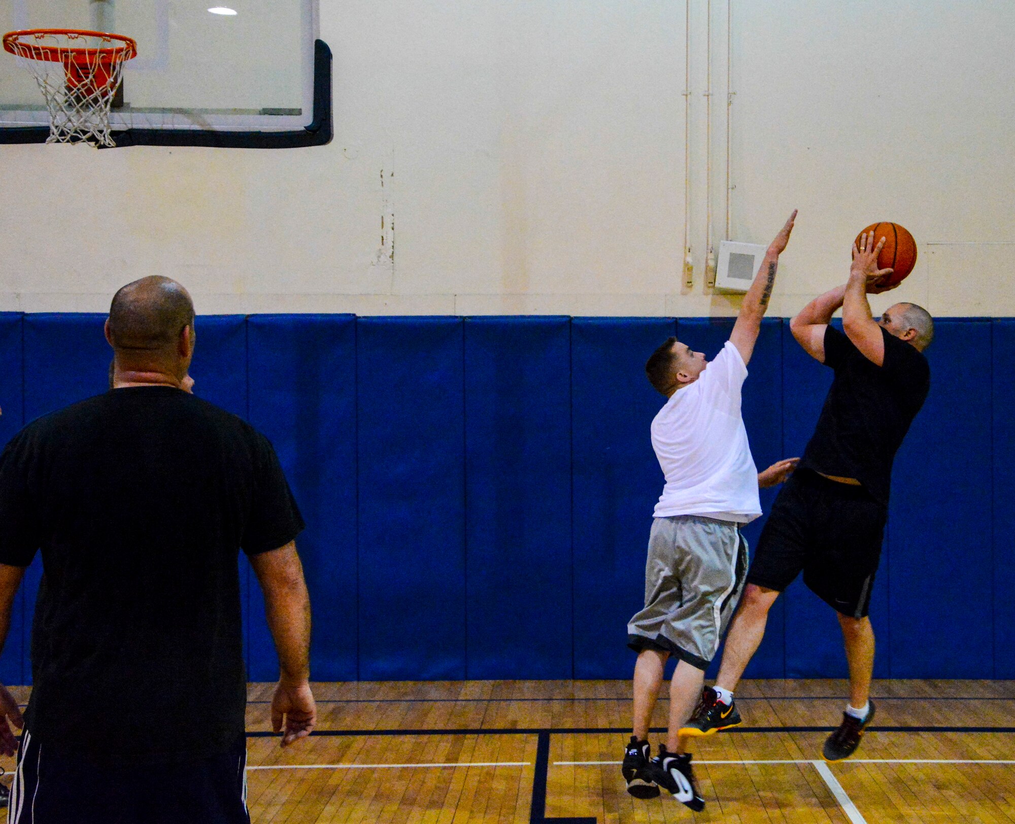 Tech. Sgt. Daniel Hose, 366th Logistics Readiness Squadron, defends the shot of Lt. Col. Todd Jensen, 366th LRS commander, during a morale basketball game at Mountain Home Air Force Base, Idaho, May 5, 2014. Sporting events bring units together and achieve morale boosts while enjoying a physical fitness session. (U.S. Air Force photo by Airman 1st Class Devin Nothstine/RELEASED)