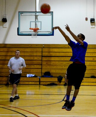 Airman 1st Class Jimaurice Lenon, 366th Equipment Maintenance Squadron, hopes to sink his shot to win the game of the epic basketball battle between the two flights at Mountain Home Air Force Base, Idaho, May 5, 2014. Morale and camaraderie between squadrons increase the effectiveness within the entire wing. (U.S. Air Force photo by Airman 1st Class Devin Nothstine/RELEASED)
