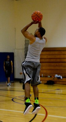 Clark Williams, 366th Logistics Readiness Squadron, shoots a three-point shot to go ahead of the command-support section during a basketball game at Mountain Home Air Force Base, Idaho, May 5, 2014. Being physically fit allows Airmen to stand out from their peers during competitions and physical fitness assessments. (U.S. Air Force photo by Airman 1st Class Devin Nothstine/RELEASED)