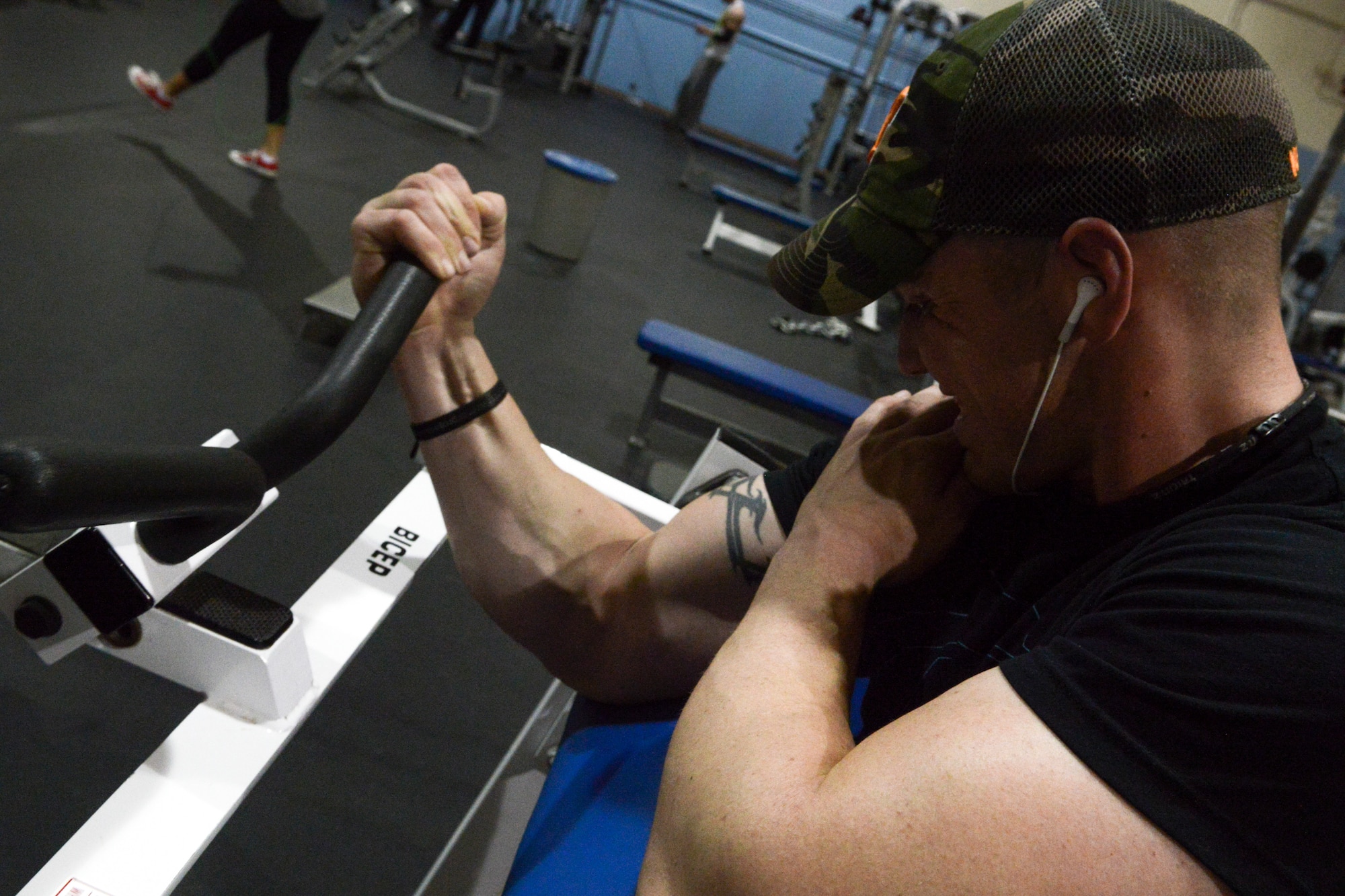 Senior Airman Dakota Beasley, 366th Logistics Readiness Squadron vehicle operator, struggles through his last set of bicep curls at Mountain Home Air Force Base, Idaho, May 4, 2014. “I enjoy seeing my body’s limitations and breaking through those limits,” said Beasley. (U.S. Air Force photo by Airman 1st Class Devin Nothstine/RELEASED)