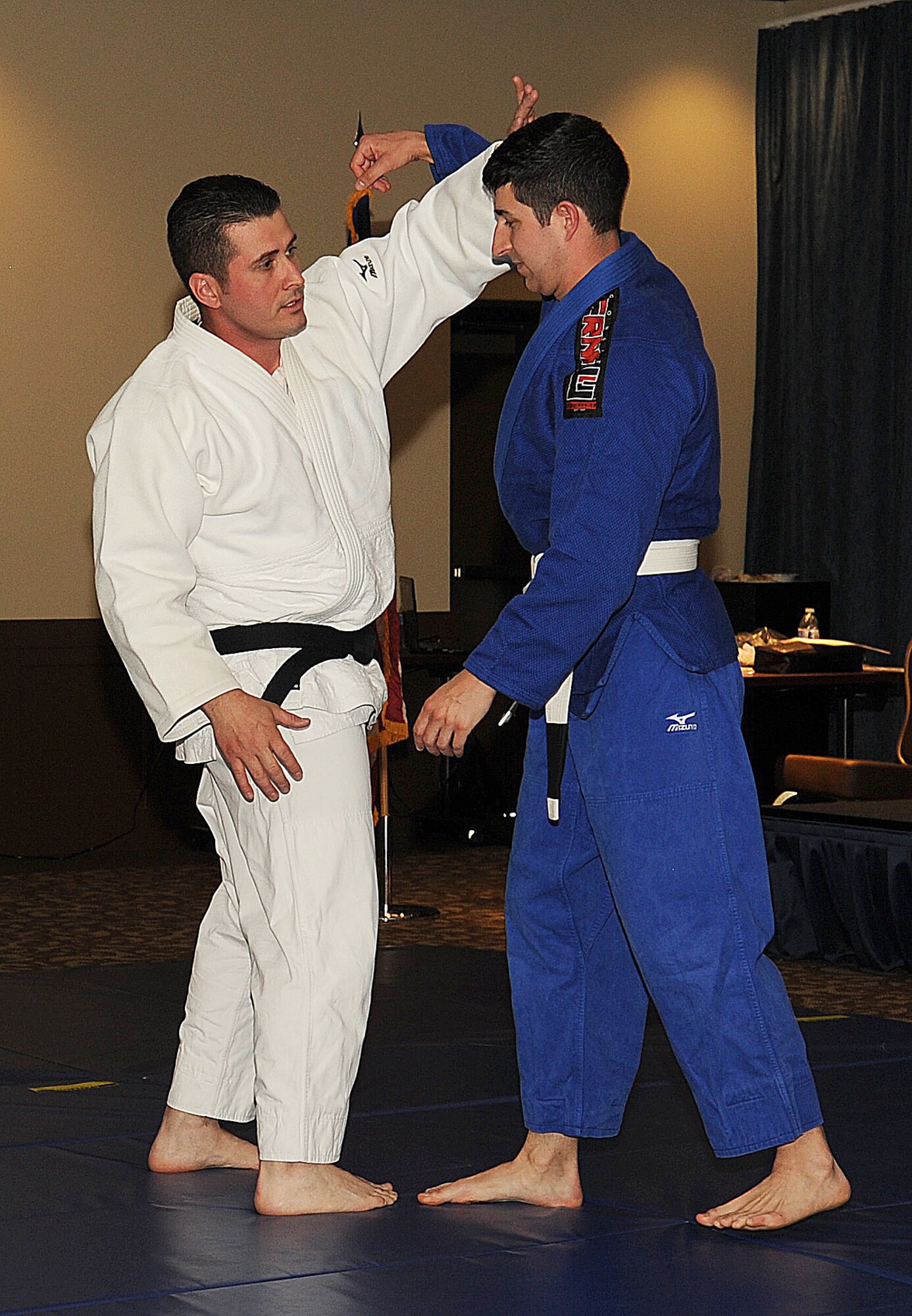 Tech. Sgt. Bruno Lima and Staff Sgt. Kevin Scott demonstrate a Judo move at the Asian Pacific American Heritage event in the Red Morgan Event Center at Fairchild Air Force Base, Wash. May 14, 2014. Judo was one of few demonstrations along with samples of Asian cuisine at the event. Lima is a 66th Training Squadron military training leader and Scott is a 92nd Force Support Squadron Airman Leadership School instructor. (U.S. Air Force photo by Staff Sgt. Samantha Krolikowski/Released)
