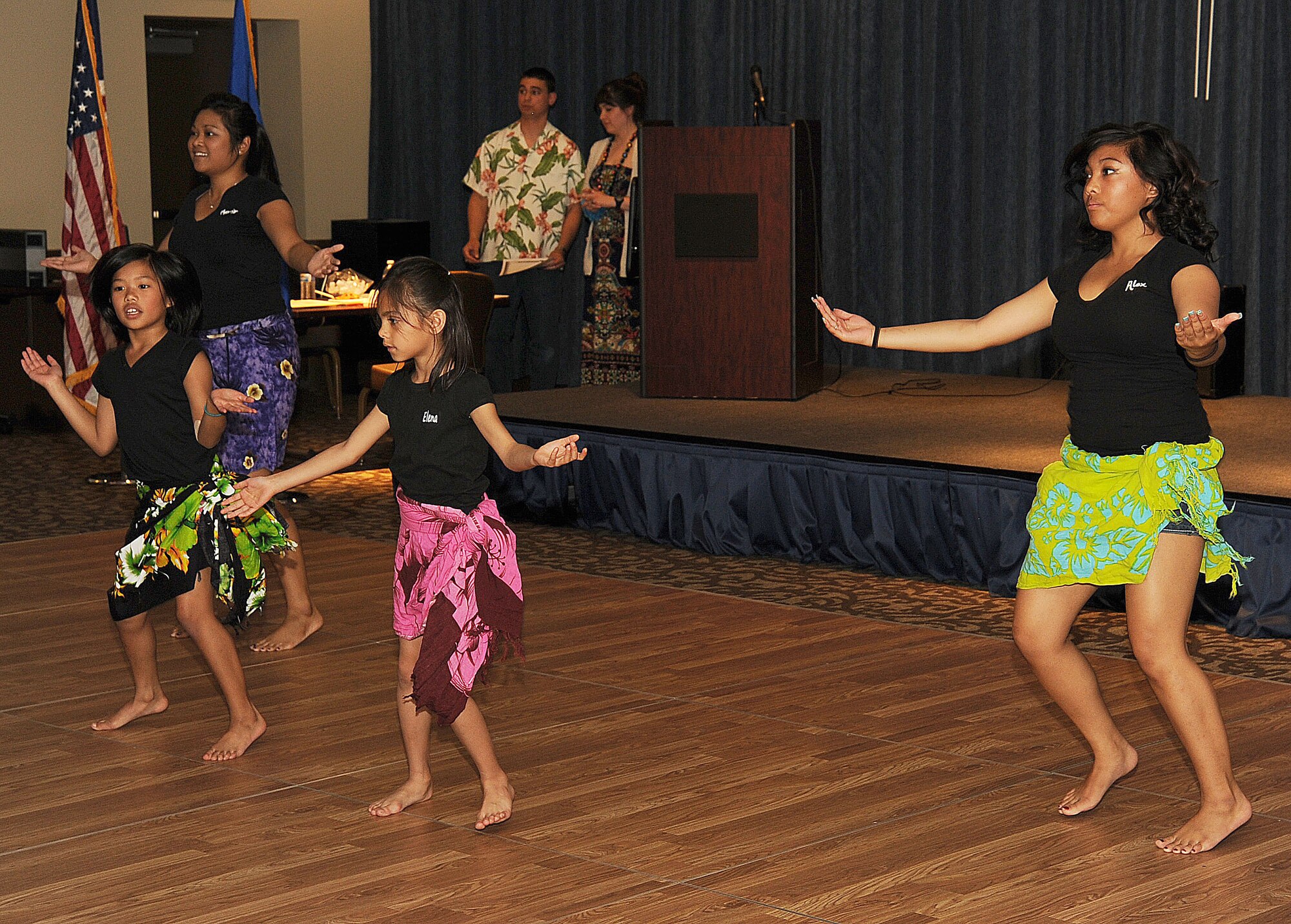 Volunteers demonstrate a hula dance at the Asian Pacific American Heritage event in the Red Morgan Event Center at Fairchild Air Force Base, Wash. May 14, 2014. The purpose of the event was to educate and enjoy fellowship in the celebration of a culture within American society. (U.S. Air Force photo by Staff Sgt. Samantha Krolikowski/Released) 