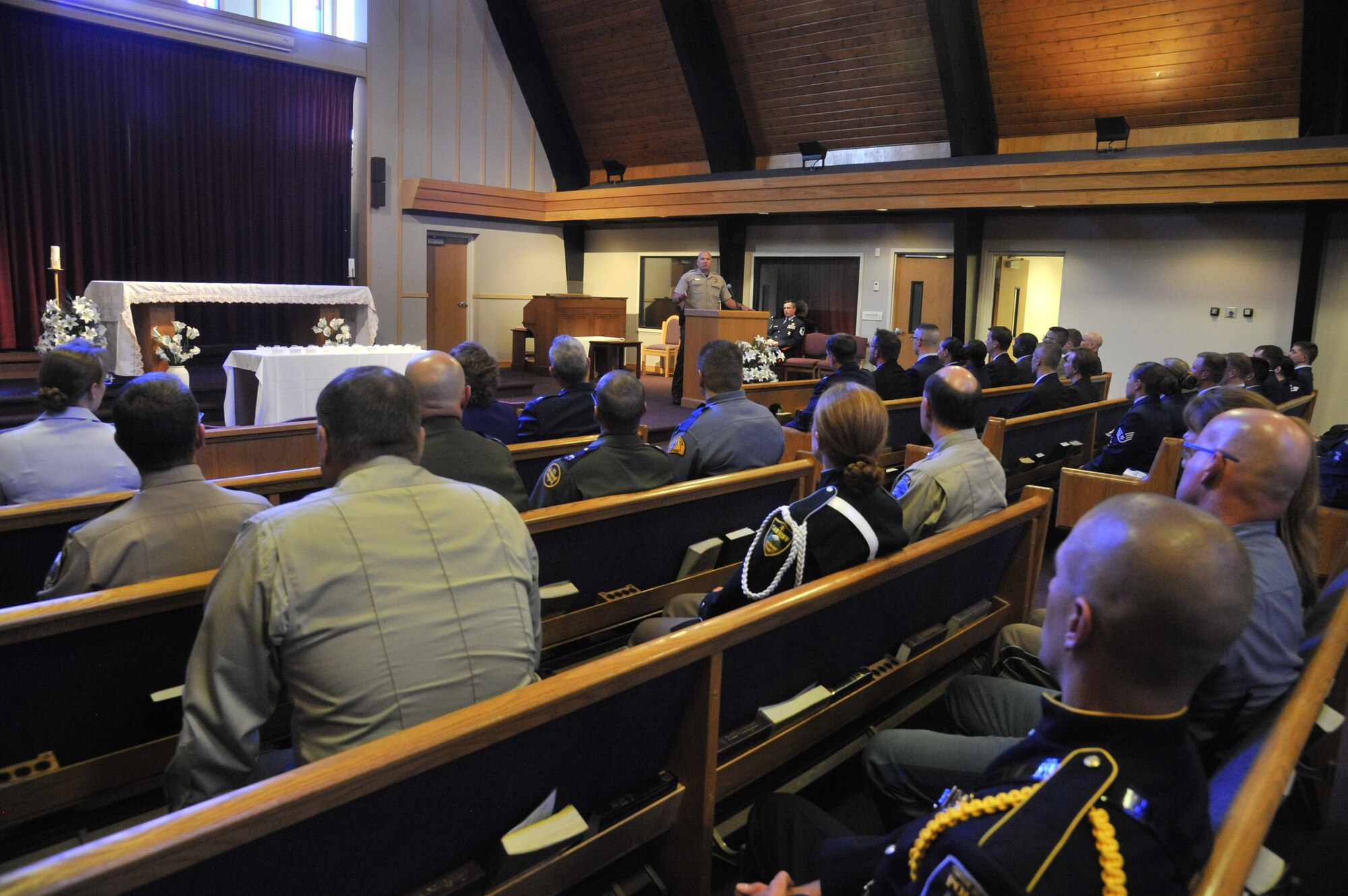 Law enforcement officers from areas surrounding Fairchild Air Force Base, Wash., gather with security forces Airmen and family members during a remembrance ceremony at the base chapel May 16, 2014. The ceremony was held during National Police Week in honor of individuals who lost their lives defending and protecting others. (U.S. Air Force photo by Senior Airman Mary O'Dell/Released)