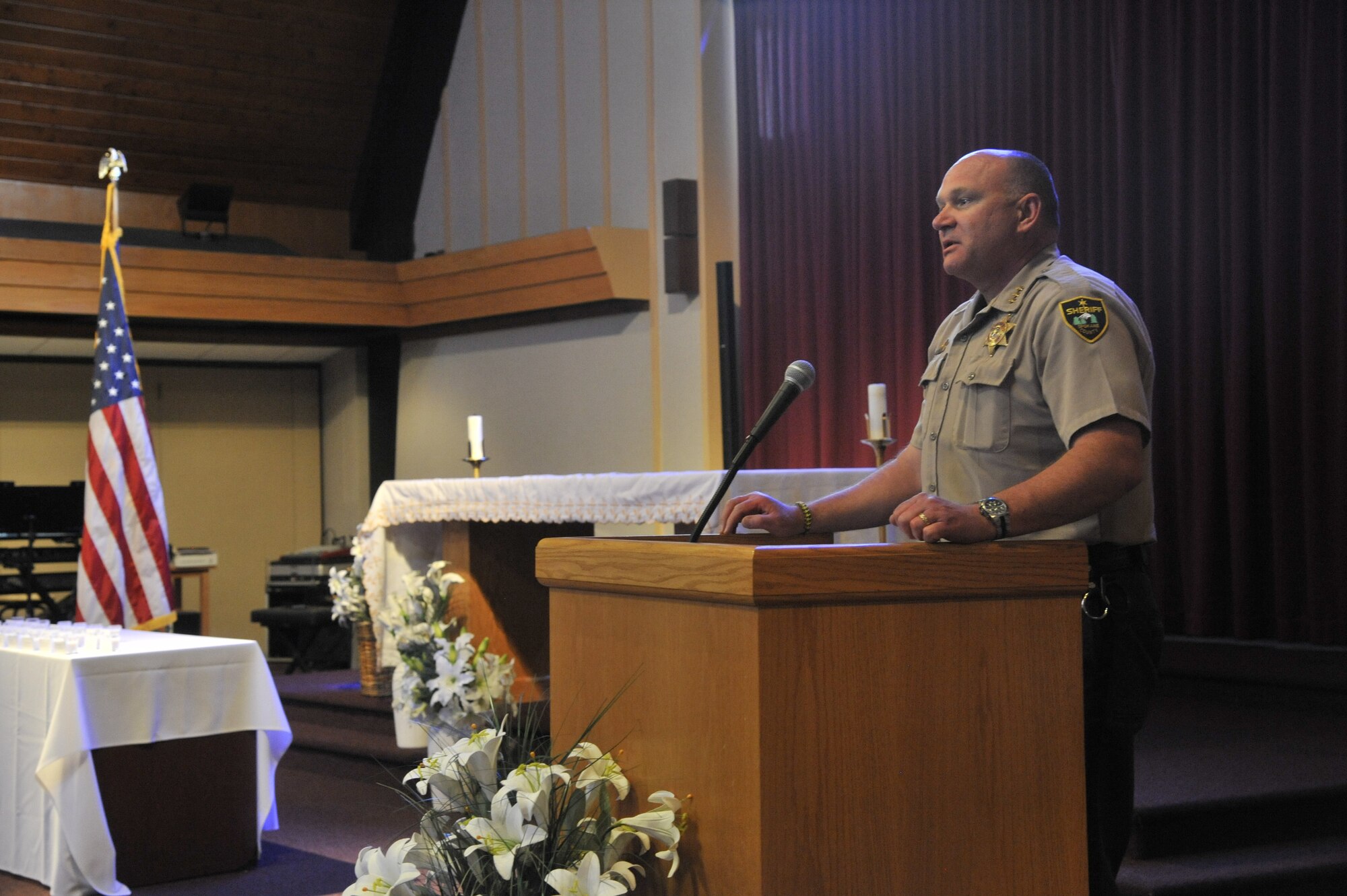 Spokane County Sheriff Ozzie Knezovich speaks with Fairchild Airmen and family members during a remembrance ceremony at Fairchild Air Force Base, Wash., May 15, 2014. This ceremony was held in honor of Peace Officer's Memorial Day to remember law enforcement officers who gave their lives in the line of duty. (U.S. Air Force photo by Senior Airman Mary O'Dell/Released)