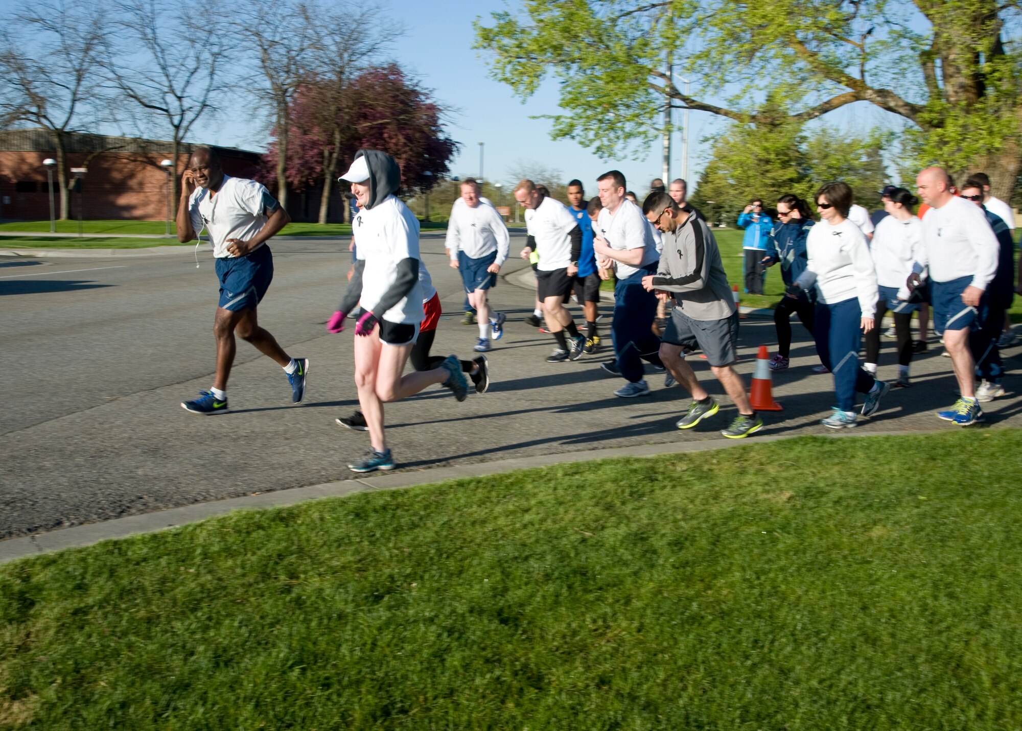 Members of the 92nd Security Forces Squadron and other base personnel begin running during a 5k in recognition of National Police Week at Fairchild Air Force Base, Wash., May 16, 2014. This national remembrance week occurs each year in recognition of the service and sacrifice of U.S. law enforcement officers who lost their lives ensuring America's safety and protection. (U.S. Air Force photo by Senior Airman Mary O'Dell/Released)