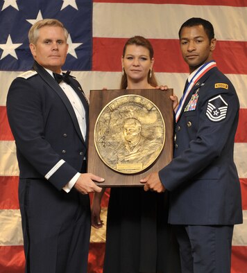 Master Sgt. Delorean Sheridan, right, from the 21st Special Tactics Squadron, is presented the Lance P. Sijan Award by Lt. Gen. Eric Fiel, Air Force Special Operations Command commander, during the 2014 Outstanding Airmen of the Year Awards Banquet at the Soundside Club on Hurlburt Field, Fla., May 15, 2014. The OAY recipients spent the two days prior to the banquet touring Hurlburt Field. (U.S. Air Force photo/ Senior Airman Kentavist P. Brackin) 