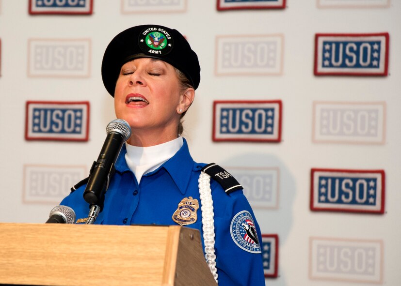 Wendy Coburn, Transportation Security Administration Honor Guard member, sings the national anthem at the beginning of the grand opening ceremony for a new USO lounge at McCarran International Airport’s Terminal 3 May 7, 2014. The USO is a nonprofit, charitable corporation chartered by Congress that relies on donations from individuals, organizations and corporations to support its programs. (U.S. Air Force photo by Tech. Sgt. S.E./Released)
