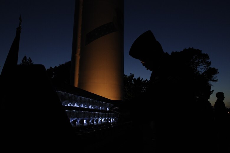 Senior Airman Devin Dotson, 30th Security Force Squadron commander’s support staff, is silhouetted as he lights a ceremonial candle during a vigil, May 15, Vandenberg Air Force Base, Calif. The ceremony was part of National Police Week and commenced with SFS members conducting a 24-hour guard of the vigil and transitioned to the reading of 120 names of those killed in the line of duty, including ten civilian officers. (U.S. Air Force photo by Senior Airman Shane Phipps/Released)
