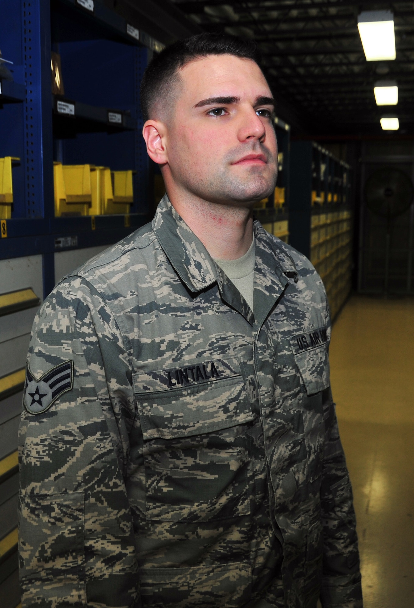 Senior Airman George Lintala, 325th Logistic Readiness Squadron materiel management journeyman, poses for a photo May 15 at Tyndall’s materiel management warehouse. Lintala was diagnosed with leukemia in 2012 while deployed to the Middle East and will be cancer-free for a year in June. (U.S. Air Force photo by Airman 1st Class Sergio A. Gamboa)