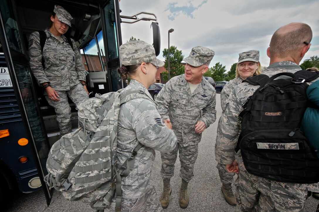 Col. James Lackey, 932nd Airlift Wing (AW) vice commander and Col. Constance Jenkins, 932nd AW Mission Support Group commander, greet Security Forces Squadron (SFS) troops as they are welcomed back to Scott Air Force Base, May 16, 2014.  The SFS Airmen were deployed for several months to an undisclosed location.  (U.S. Air Force photo by Tech. Sgt. Christopher Parr)  