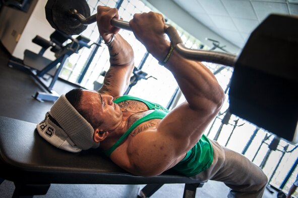 U.S. Air Force Staff Sgt. Israel Garza, 23d Security Forces Squadron unit trainer, performs “skullcrusher” triceps exercises at Moody Air Force Base, Ga., March 7, 2014. During a deployment to Afghanistan, several improvised explosive device attacks left Garza with severe back pain from his muscles and bones putting pressure on the Sciatic nerve on his left side. (U.S. Air Force photo by Senior Airman Jarrod Grammel/Released)
