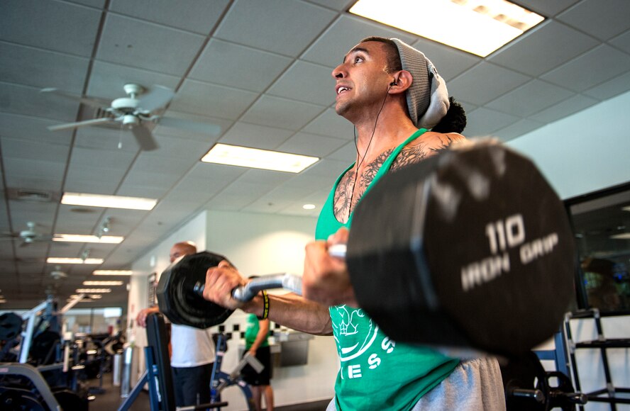 U.S. Air Force Staff Sgt. Israel Garza, 23d Security Forces Squadron unit trainer, performs bicep curls at Moody Air Force Base, Ga., March 7, 2014. While preparing for his upcoming bodybuilding competition, Garza focuses his workouts on higher repetitions and sets with lower weight, while slowing down the movements. (U.S. Air Force photo by Senior Airman Jarrod Grammel/Released)
