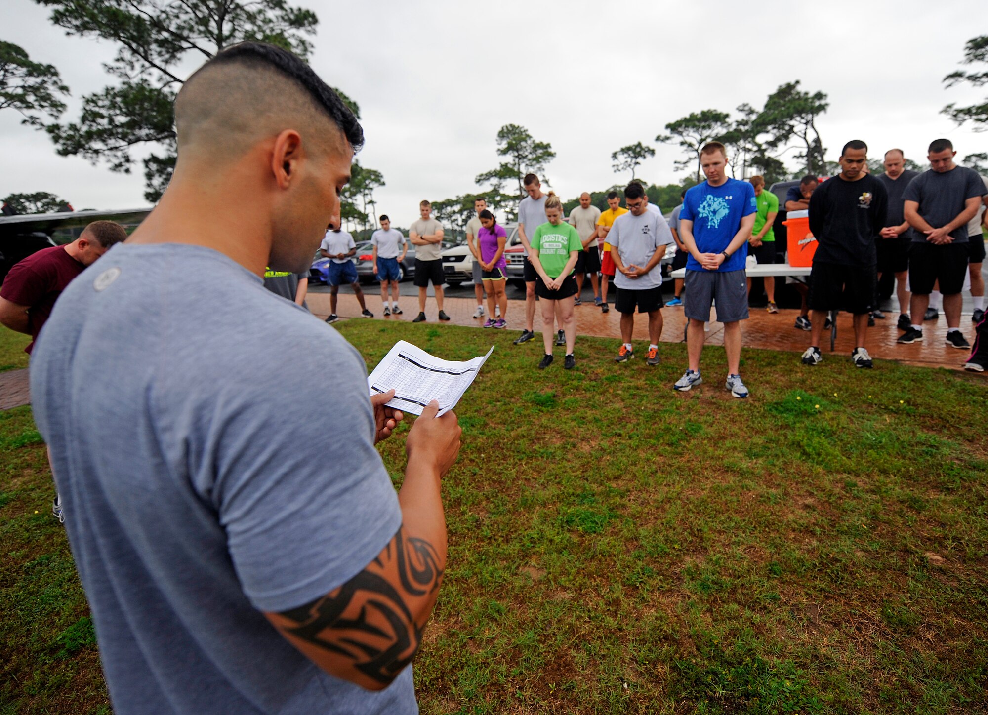 Staff Sgt. Christopher Mendez, 1st Special Operations Logistics Readiness Squadron air transportation journeyman, reads the names of deceased Airmen at Hurlburt Field, Fla., May 14, 2014. The Airmen gathered for a 5K run to honor Air Transportation Airmen who lost their lives while serving in the Air Force. (U.S. Air Force photo/Staff Sgt. Jeff Andrejcik)  