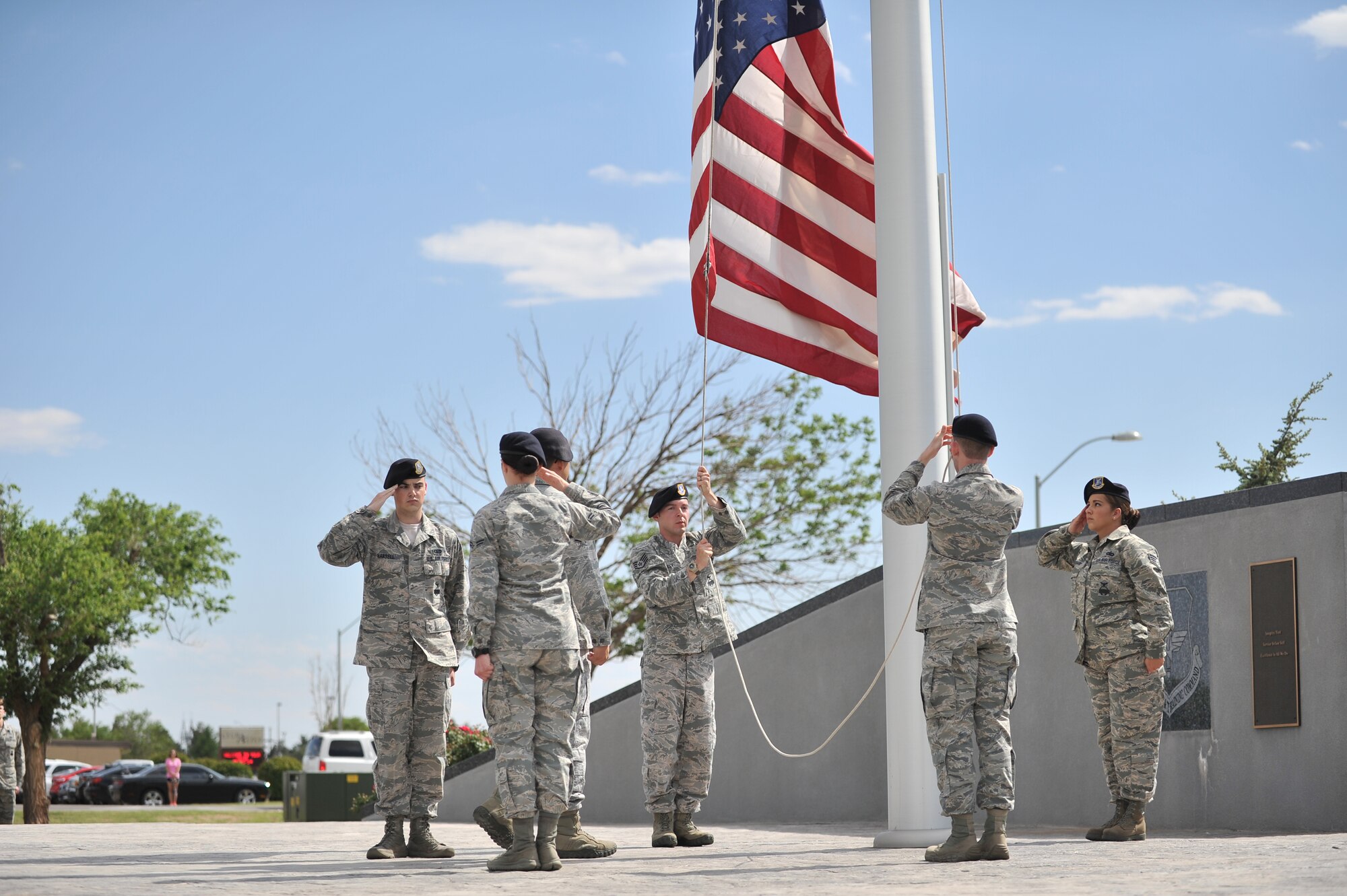 ALTUS AIR FORCE BASE, Okla. – Airmen from the 97th Security Forces Squadron lower the U.S. flag during the annual Police Week retreat ceremony at the Wings of Freedom Park May 15, 2014. The ceremony was held in honor of all law-enforcement officers’ lives lost in the past year. Police Week events included: The Sheep Dog Shootout, the “Gut Check” Challenge, wreath laying and retreat ceremonies and concluded with a golf tournament. (U.S. Air Force photo by Senior Airman Dillon Davis/Released)