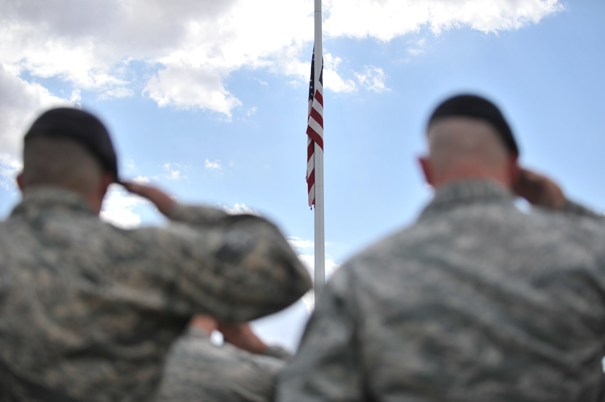 ALTUS AIR FORCE BASE, Okla. – Airmen from the 97th Security Forces Squadron salute the U.S. flag during the annual Police Week retreat ceremony at the Wings of Freedom Park May 15, 2014. The ceremony was held in honor of all law-enforcement officers’ lives lost in the past year. Police Week events included: The Sheep Dog Shootout, the “Gut Check” Challenge, wreath laying and retreat ceremonies and concluded with a golf tournament. (U.S. Air Force photo by Senior Airman Dillon Davis/Released)