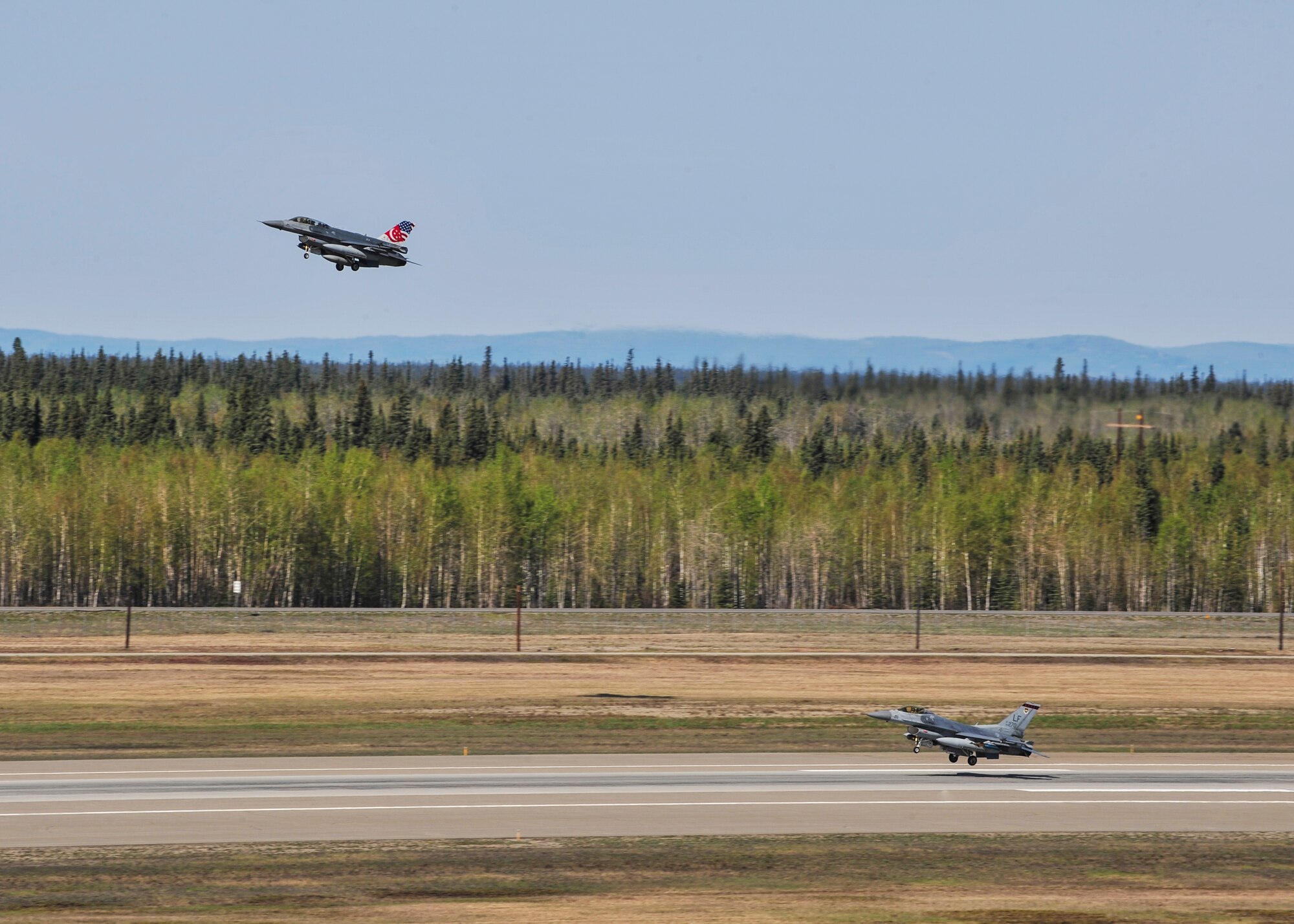 Two Republic of Singapore Air Force F-16 Fighting Falcons assigned to the 425th Fighter Squadron, Luke Air Force Base, Ariz., prepare to land during RED FLAG-Alaska 14-1 May 14, 2014, Eielson Air Force Base, Alaska. RF-A provides allied pilots, aircrew and operational support personnel with a training area of more than 65,000 square miles. (U.S. Air Force photo by Senior Airman Ashley Nicole Taylor/Released)