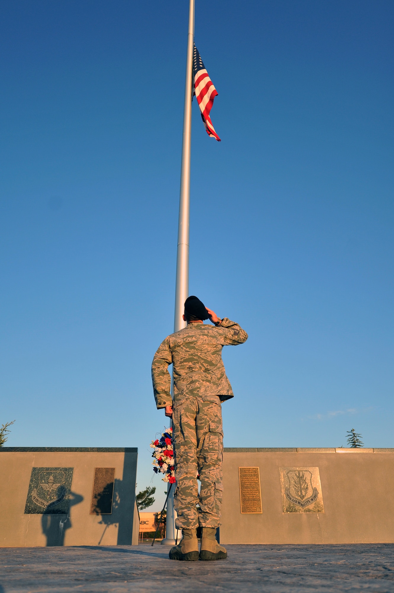 ALTUS AIR FORCE BASE, Okla. – An Airman from the 97th Security Forces Squadron salutes the American Flag during his guard duty following the annual Police Week wreath laying ceremony at the Wings of Freedom Park May 15, 2014. Airmen from the 97th traded shifts standing guard of the wreath until the retreat ceremony later that day to show respect for law-enforcement officers who have been killed in the line of duty. Police Week events included: The Sheep Dog Shootout, the “Gut Check” Challenge, wreath laying and retreat ceremonies and concluded with a golf tournament. (U.S. Air Force photo by Senior Airman Dillon Davis/Released)