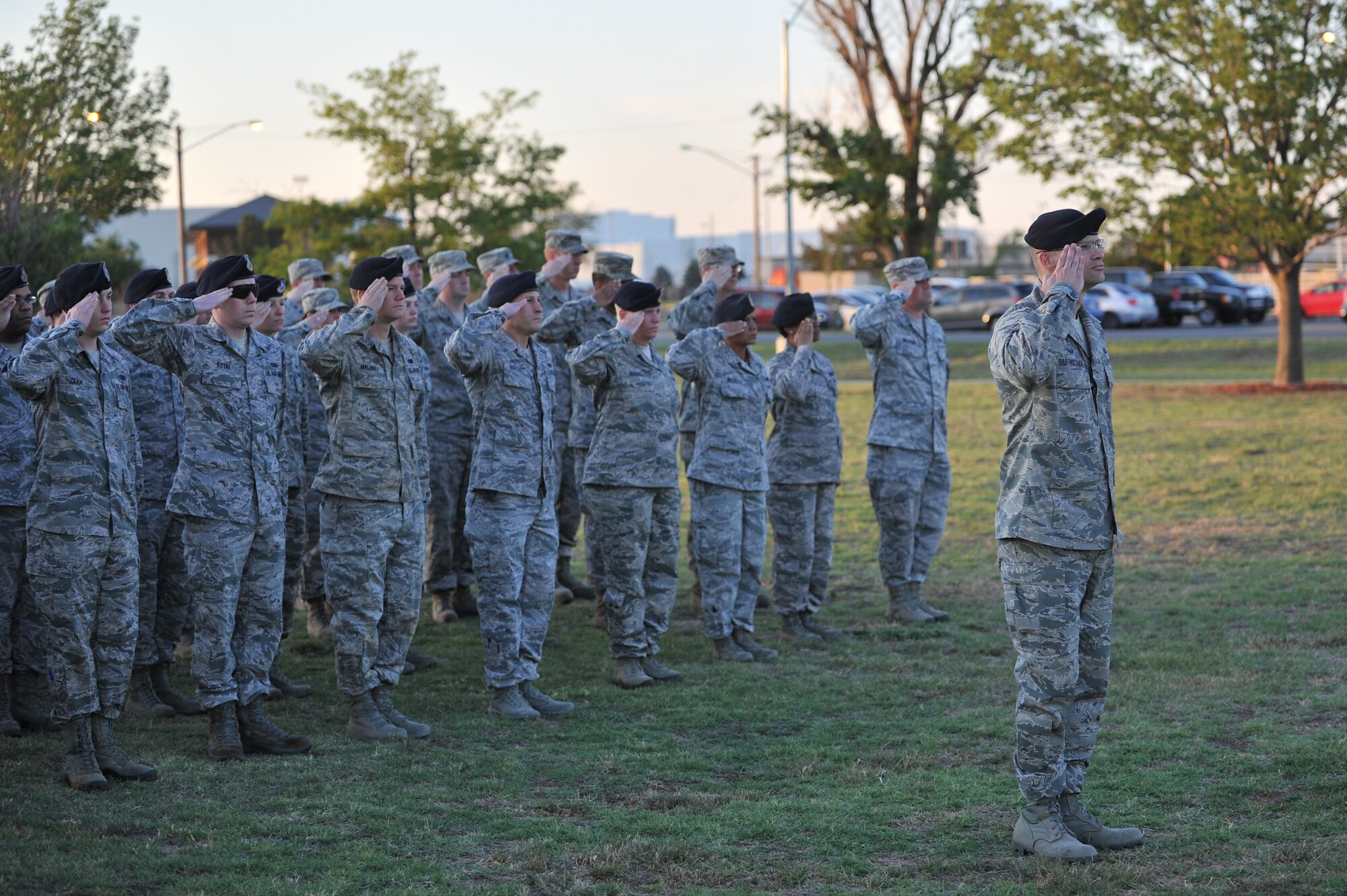ALTUS AIR FORCE BASE, Okla. – Airmen from the 97th Security Forces Squadron salute in formation during the annual Police Week wreath laying ceremony at the Wings of Freedom Park May 15, 2014. The wreath symbolizes law-enforcement officers who have fallen in the line of duty and pays respect to those who have made the ultimate sacrifice. Police Week events included: The Sheep Dog Shootout, the “Gut Check” Challenge, wreath laying and retreat ceremonies and concluded with a golf tournament. (U.S. Air Force photo by Senior Airman Dillon Davis/Released)