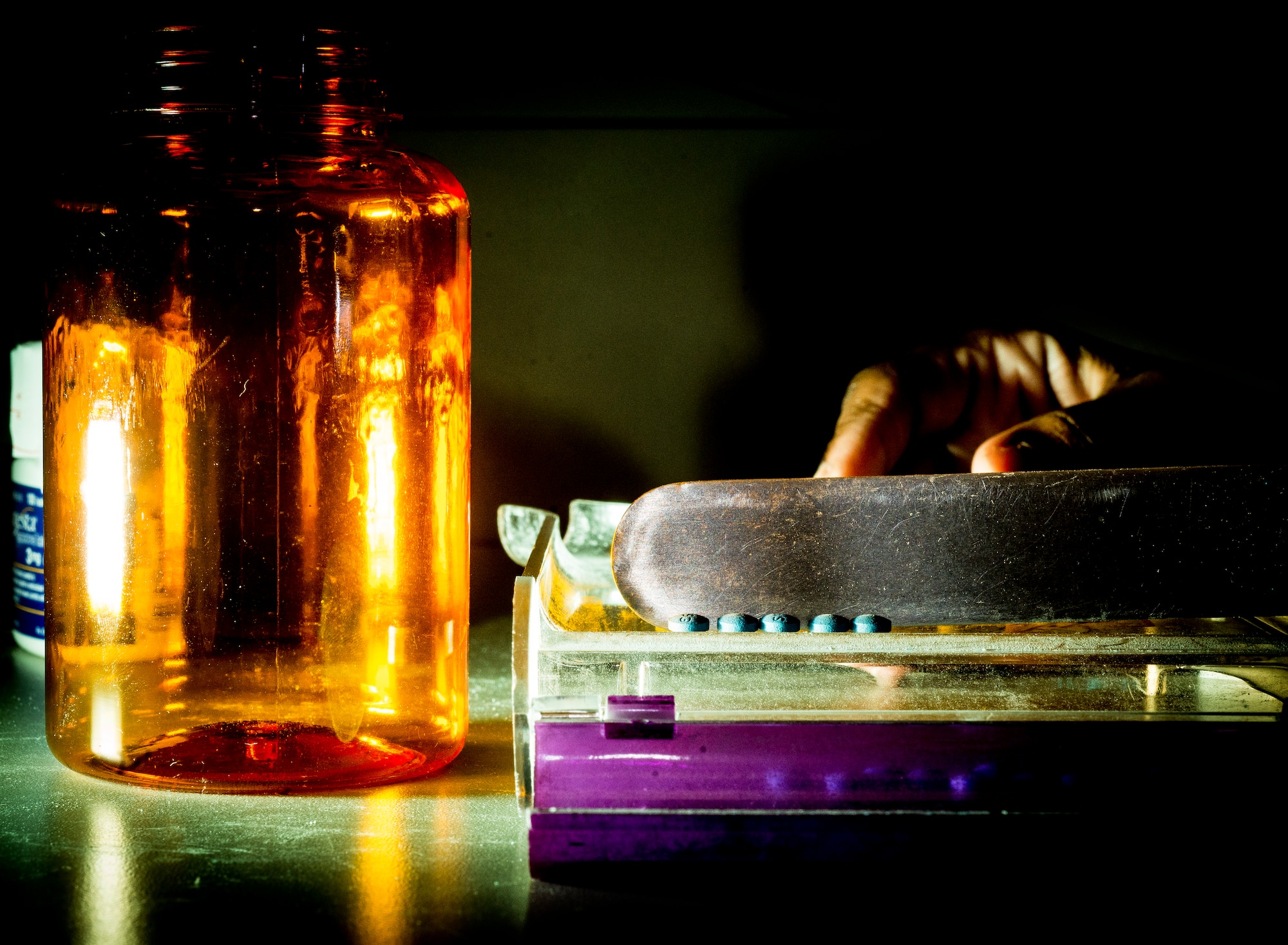 Kionte Bryant, 628th Medical Group pharmacy technician, counts medicine pills to fill a prescription May 15, 2014, at Joint Base Charleston, S.C. The pharmacy technicians fill prescriptions for active duty, reservists, retirees and dependents of military members. (U.S. Air Force photo/ Senior Airman Dennis Sloan)