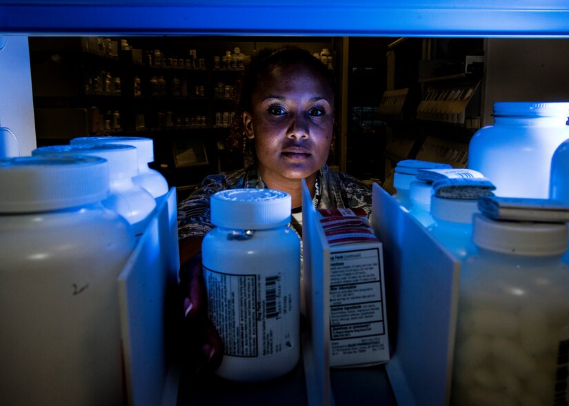 Tech. Sgt. Rikkieta Jones, 628th Medical Group pharmacy technician, reaches for a bottle of medicine to fill a prescription May 15, 2014, at Joint Base Charleston, S.C. The pharmacy technicians fill prescriptions for active duty, reservists, retirees and dependents of military members. (U.S. Air Force photo/ Senior Airman Dennis Sloan)