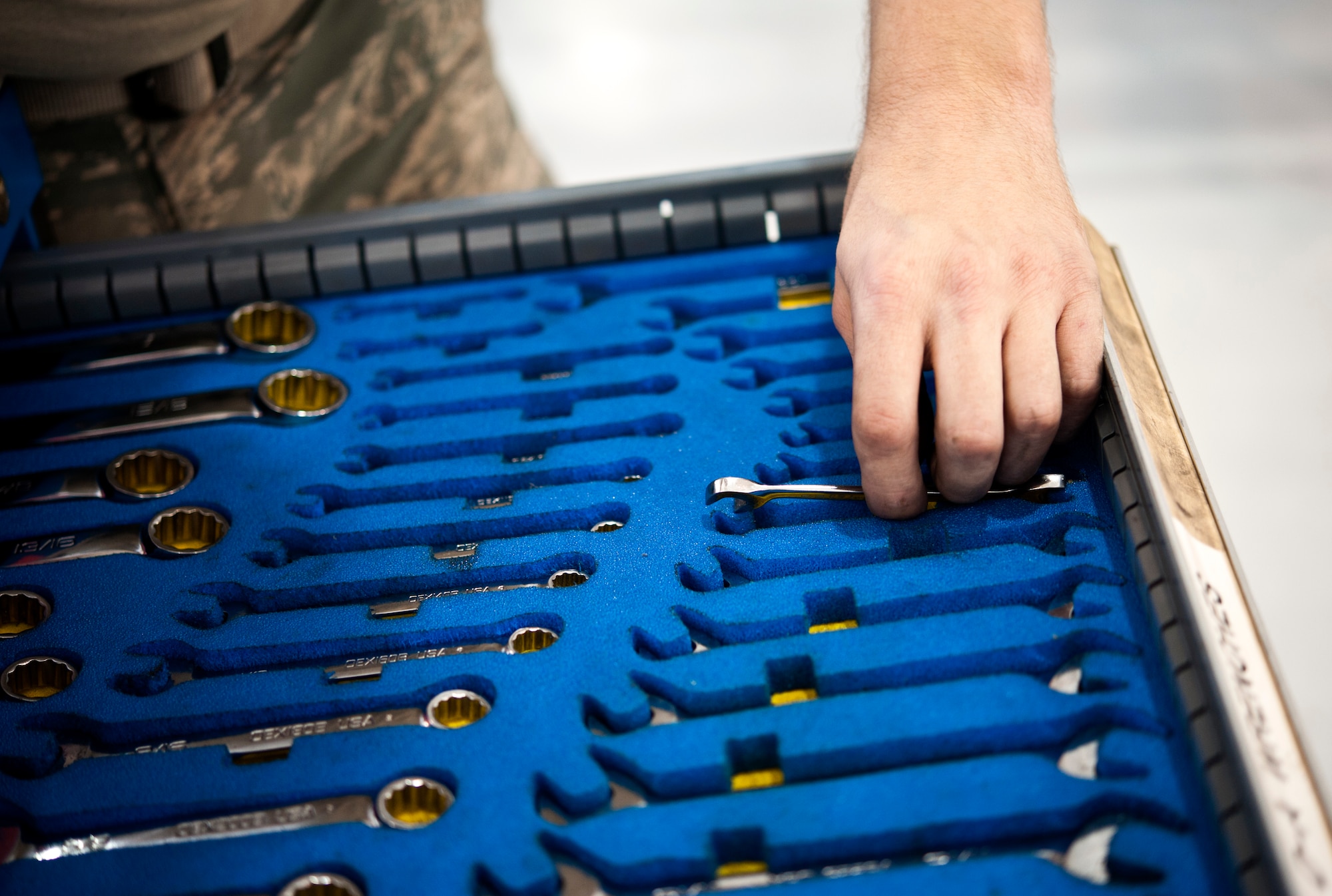 Senior Airman Daniel Hensley, 442nd Aircraft Maintenance Squadron electro-environmental technician from Sedalia, Missouri, grabs a wrench, May 15, 2014 at Whiteman Air Force Base, Missouri. Electro-environment technicians are responsible for performing and supervising aircraft electrical and environmental functions and activities. (U.S. Air Force photo by Senior Airman Daniel Phelps/Released)