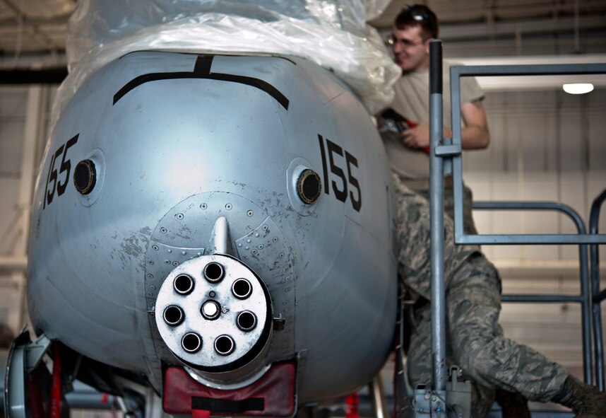 Senior Airman Daniel Hensley, from Sedalia, Missouri, and Master Sgt. Richard Huff, from Sibley, perform maintenance work on an A-10 Thunderbolt II May 15, 2014 at Whiteman Air Force Base, Missouri. Hensley and Hoff are both assigned to the 442nd Aircraft Maintenance Squadron electro-environmental shop. (U.S. Air Force photo by Senior Airman Daniel Phelps/Released)