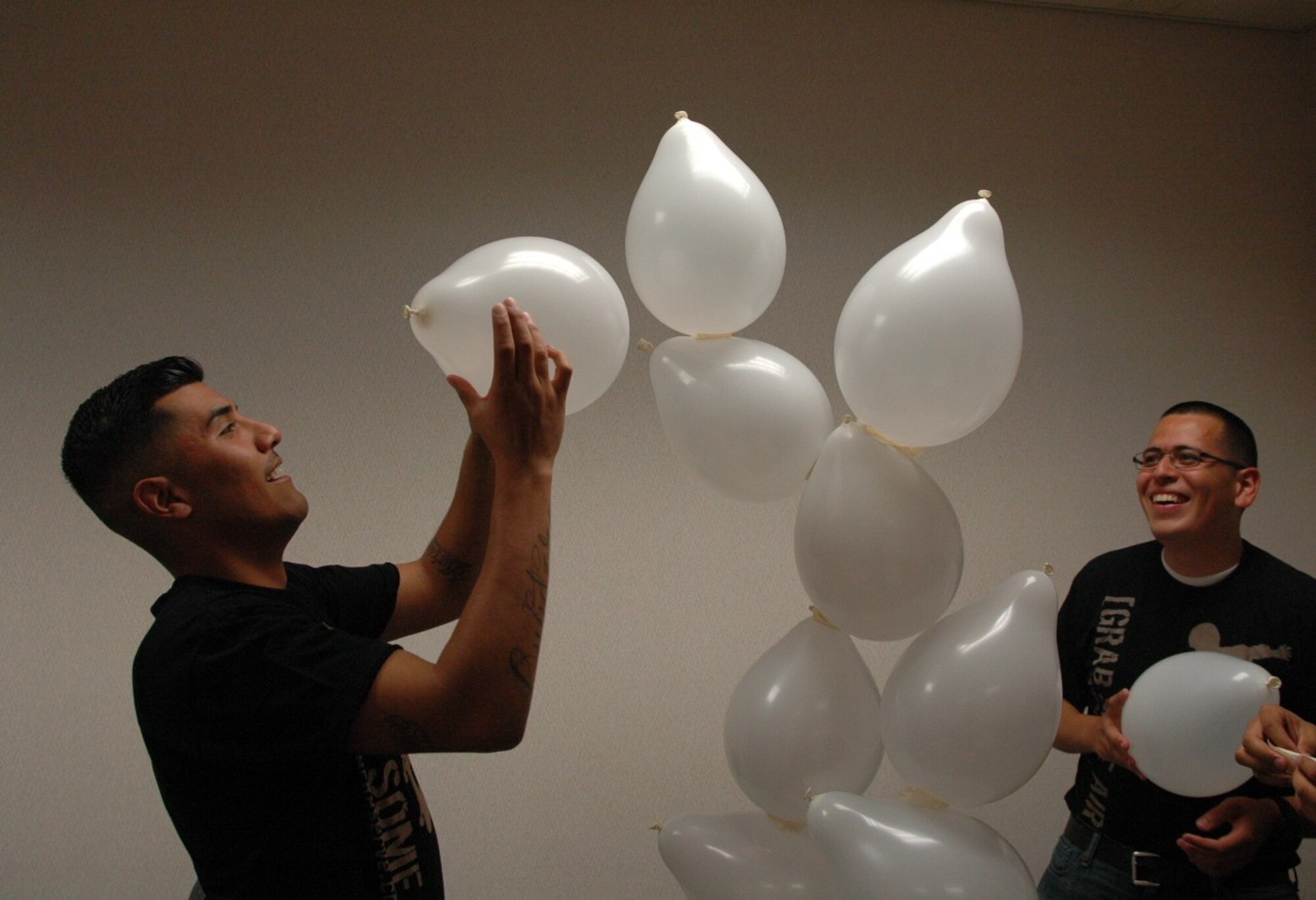 940th Wing Developmental Training Flight members Guillemo Herrera (right), from Elk Grove, California, and Marco Aranada, from Sacramento, California, build a tower of balloons in a teambuilding exercise during a recent Unit Training Assembly on Beale Air Force Base, California, May 3. The aim of the activity was to develop skills the trainees will need to become productive airmen in the Air Force Reserve, said Master Sgt. Veronica Rooks, DTF program manager. (U.S. Air Force photo by Dana Lineback)
