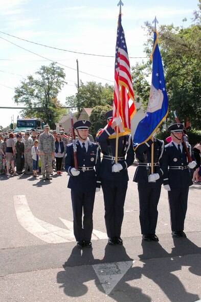 Members of the Travis Honor Guard stand ready to lead Travis Airmen and their families down the parade route of the 2014 Dixon May Fair Parade May 10. The Airmen are comprised of the 60th Wing Staff agencies as well as Travis Airmen from both Reserve and active-duty organizations. (U.S. Air Force photo/Senior Airman Bryan Swink)

