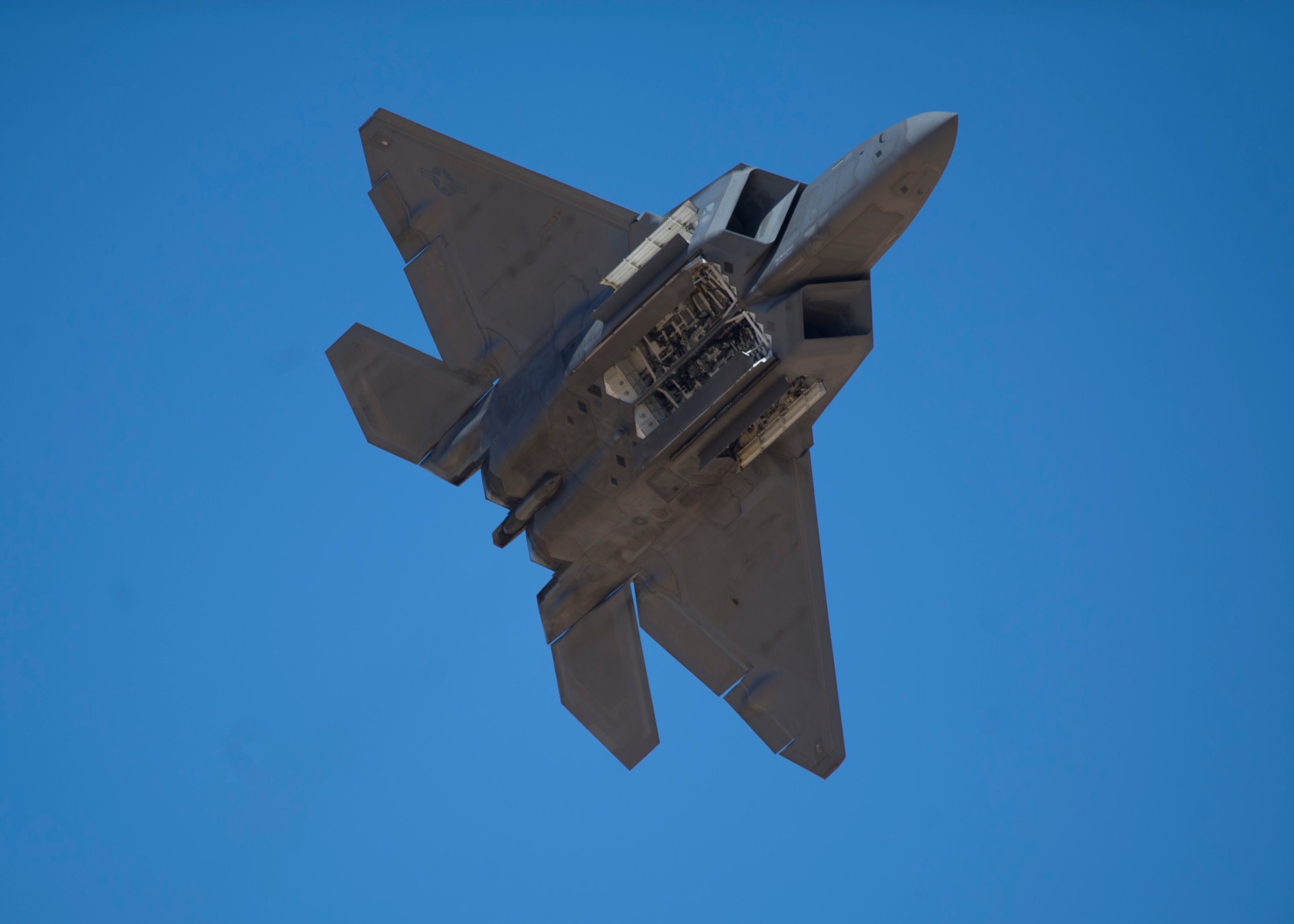 A F-22 Raptor flies through the skies of the Tularosa Basin during the Open House event at Holloman Air Force Base N.M., May 10. Team Holloman hosted an Open House showcasing over 50 aircraft and the day-to-day duties of Holloman Airmen. With live flying demonstrations and static displays, thousands of guests attended the event to get a close-up look at the base’s assets and capabilities. Guests were able to view various aircraft, visit numerous vendors, and witness ground demonstrations from squadrons around the base. (U.S. Air Force photo by Airman 1st Class Chase Cannon/ Released)